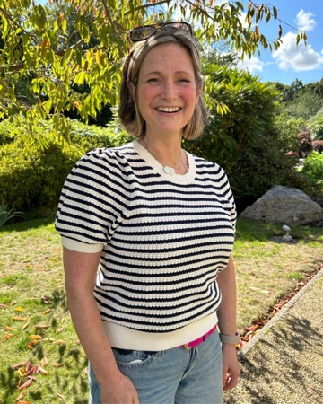 Woman stands in the Hospice garden