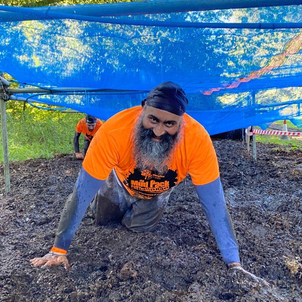 Man crawling through mud