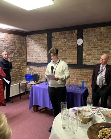 Teenage boy speaks to audience