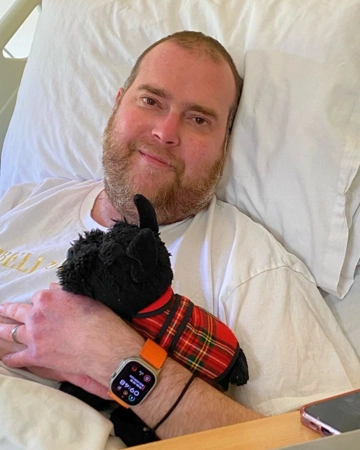 Man holds stuffed toy in hospice bed